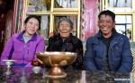 April 13,2021 -- Penpa Tsamjo (C) and her grandson and granddaughter-in-law pose for a photo in Xigaze, southwest China`s Tibet Autonomous Region, March 19, 2021. The 92-year-old Penpa Tsamjo is a resident of Bomuqing community in Xigaze. In old Tibet, Penpa Tsamjo`s family had been serfs for generations. When she was a child, Penpa Tsamjo tended forest for serf owners and did not have enough food to eat. Nowadays, Penpa Tsamjo has a family of four generations and enjoys a happy life at her old age. (Xinhua/Zhang Rufeng)