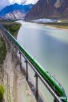 June 28,2021 -- Aerial photo taken on June 16, 2021 shows a Fuxing bullet train running on the Lhasa-Nyingchi railway over the Yarlung Zangbo River during a trial operation. [Photo/Xinhua]
