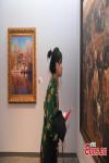 Sept.30,2021 -- A visitor appreciates a Tibet-themed painting at the Natural Science Museum in Lhasa, capital of southwest China`s Tibet Autonomous Region, Sept. 26, 2021. (China News Service/Gongga Laisong)