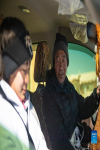 Thutop (R) looks at his daughter Tenzin Drolma in Gyaga Village of Damxung County, southwest China`s Tibet Autonomous Region, Jan. 18, 2022.