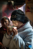 Tenzin Drolma drinks fresh milk in Gyaga Village of Damxung County, southwest China`s Tibet Autonomous Region, Jan. 18, 2022.