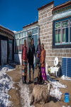 Tenzin Drolma (2nd R) poses for pictures with her family in Gyaga Village of Damxung County, southwest China`s Tibet Autonomous Region, Jan. 18, 2022.