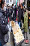 A vendor sells traditional stuff at a bazaarin Lhasa, southwest China`s Tibet Autonomous Region, Feb 27, 2022. As Losar, or Tibetan New Year, draws near, people in Lhasa get busy with their annual shopping. (Photo: China News Service/Jiang Feibo)