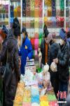 Locals shop at a bazaar in Lhasa, southwest China`s Tibet Autonomous Region, Feb 27, 2022. As Losar, or Tibetan New Year, draws near, people in Lhasa get busy with their annual shopping. (Photo: China News Service/Jiang Feibo)