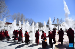 Monks throw zanba, a traditional Tibetan staple food made of roasted barley flour, into the sky to pray for good weather during a ceremonial event at Tashilumpo Monastery in Xigaze City of southwest China`s Tibet Autonomous Region, March 7, 2022. A ceremonial event was held at the monastery on Monday. (Xinhua/Chogo)