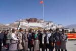 People pose for photos at the Potala Palace in Lhasa, Tibet, to celebrate Serfs Emancipation Day on Monday. [Photo provided to chinadaily.com.cn]