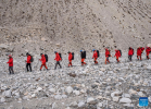 Members of a Chinese scientific expedition team are on the way back to the Mount Qomolangma base camp on May 5, 2022. A Chinese scientific expedition team returned safely to the Mount Qomolangma base camp on Thursday, after reaching the summit of the world`s highest peak. All 13 members of the expedition team are in good physical condition. (Xinhua/Sun Fei)