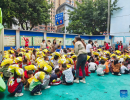 Children are evacuated to the playground in a kindergarten in Shimian county of Ya`an city, Southwest China`s Sichuan province, Sept 5, 2022. [Photo/Xinhua]
