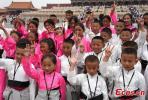Tibetan children from the Welfare Center of Tibetan Autonomous Prefecture of Yushu in northwest China`s Qinghai Province pose for a photo in the Palace Museum, Beijing, May 31, 2023. (Photo/China News Service/Cui Nan)
