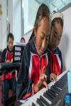 Pupils attend a piano class at a primary school of Zhaxizom Township in Tingri County, Xigaze City, southwest China`s Tibet Autonomous Region, June 5, 2023.