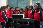 Piano teacher Basang (C) instructs students at a primary school of Zhaxizom Township in Tingri County, Xigaze City, southwest China`s Tibet Autonomous Region, June 5, 2023.