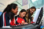 Piano teacher Basang (R) instructs students at a primary school of Zhaxizom Township in Tingri County, Xigaze City, southwest China`s Tibet Autonomous Region, June 5, 2023.