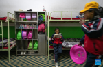 A pupil reads at the dormitory at a primary school of Zhaxizom Township in Tingri County, Xigaze City, southwest China`s Tibet Autonomous Region, June 5, 2023.