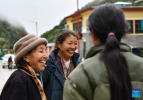Zhoigar (L) and Yangzom talk with people in a street at Yumai Township in Shannan City, southwest China`s Tibet Autonomous Region, June 10, 2023.  (Xinhua/Jigme Dorji)