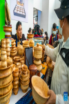 Visitors choose wooden bowls during the 5th China Xizang Tourism and Culture Expo in Lhasa, southwest China`s Tibet Autonomous Region, June 17, 2023. The 5th China Xizang Tourism and Culture Expo opened here on Friday. The three-day expo is one of the most important events on Tibet`s cultural calendar. Nearly 1,000 businesses from home and abroad have attended the event, bringing about 10,000 different products. (Xinhua/Sun Fei)