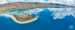 This stitched aerial photo taken on July 22, 2023 shows the Rituo Temple on the north shore of Yumzhog Yumco Lake in southwest China`s Tibet Autonomous Region. (Xinhua/Nie Yi)