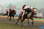 Horsemen pick up ceremonial hada scarfs during a horse racing festival in Yushu Tibetan Autonomous Prefecture, northwest China`s Qinghai Province, July 25, 2023. (Xinhua/Gao Wei)