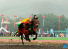 A horseman picks up a ceremonial hada scarf during a horse racing festival in Yushu Tibetan Autonomous Prefecture, northwest China`s Qinghai Province, July 25, 2023. (Xinhua/Gao Wei)