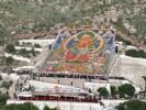 People visit a giant thangka marking the start of the annual Shoton Festival on Wednesday in Lhasa. [Photo by Daqiong/chinadaily.com.cn]