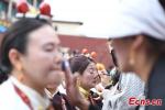 Tibetans put on makeup during a traditional Guozhuang dance contest at a local festival in Qamdo City, southwest China`s Tibet Autonomous Region, Aug. 20, 2023. (Photo/China News Service)