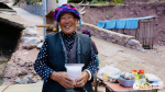 A villager smiles as she holds a bag of salt. (People`s Daily Online/Tsering Norbu)