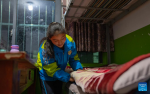 Sichod Drolma arranges her bed and prepares to sleep in the dormitory at Damxung County Middle School in Damxung County, southwest China`s Xizang Autonomous Region, Nov. 9, 2023. (Photo by Tenzin Nyida/Xinhua)