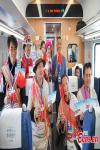 Passengers celebrate onboard the first train from Shangri-La to Lijiang in southwest China`s Yunnan Province, Nov. 26, 2023. (Photo: China News Service/Liu Ranyang)