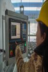 A staff member operates at the console of a 3D printed construction machine in Lhasa, Xizang autonomous region on Dec 12, 2023. [Photo/Xinhua]