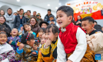 Children watch a puppet show during a party at a bookstore in Lhasa, southwest China`s Xizang Autonomous Region, Feb. 3, 2024.  A unique party was held on Saturday at a bookstore for children in Lhasa City where teachers introduced the traditional customs of the Tibetan New Year. During the event, children wearing traditional Tibetan costumes enjoyed musical performance, puppet show and handicraft making, as well as a feast of `gutu`, a traditional soup dish made of flour. (Photo by Tenzin Nyida/Xinhua)
