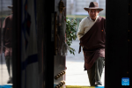 Drakpa Wangden walks into his home at Yabda Village of Doilungdeqen District in Lhasa, southwest China`s Xizang Autonomous Region, March 11, 2024. (Xinhua/Jiang Fan)
