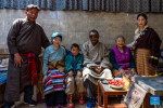 Padma (4th L) poses for a photo with his family at his residence in Shannan, southwest China`s Xizang Autonomous Region, March 27, 2024. Padma was born into a herdsman family in 1942 in Xainza County in Nagqu City, southwest China`s Xizang Autonomous Region. During his childhood, his family was obliged to herd over 1,000 sheep for aristocrats, only receiving meager sustenance in return.(Xinhua/Ding Ting)