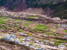 Aerial photo shows peach flowers blooming amid the fields and the village houses nearby in Lhari county, Nagqu city, southwest China`s Xizang Autonomous Region. (Photo/People`s Daily Online)