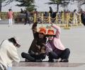 Tourists pose for photos near the Potala Palace - a UNESCO cultural heritage site in Lhasa, Xizang autonomous region. [Photo by Palden Nyima/chinadaily.com.cn]