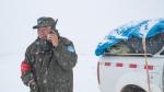 A ranger communicates via satellite phone amid snowfall at the Changtang National Nature Reserve in Nyima County of southwest China`s Xizang Autonomous Region, May 7, 2024. (Xinhua/Tenzin Nyida)