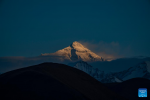 This photo taken on May 19, 2024 from Zhaxizom Township in Tingri County of Xigaze City in southwest China`s Xizang Autonomous Region shows a view of Mount Qomolangma at sunset. (Xinhua/Sun Fei)