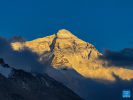 This photo taken on May 23, 2024 shows a view of the Mount Qomolangma at sunset in southwest China`s Xizang Autonomous Region. The Mount Qomolangma National Park has entered peak tourism season. From Jan. 1 to May 20 this year, the Mount Qomolangma scenic spot has received about 136,000 tourists. (Xinhua/Ding Ting)