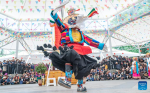 A folk artist stages a Tibetan opera performance near the Potala Palace in Lhasa, southwest China`s Xizang Autonomous Region, June 11, 2024. A five-day Tibetan opera show kicked off here on June 9. (Xinhua/Tenzin Nyida)