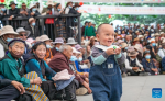 People watch Tibetan opera performances near the Potala Palace in Lhasa, southwest China`s Xizang Autonomous Region, June 11, 2024. A five-day Tibetan opera show kicked off here on June 9. (Xinhua/Tenzin Nyida)