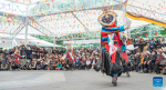 A folk artist stages a Tibetan opera performance near the Potala Palace in Lhasa, southwest China`s Xizang Autonomous Region, June 11, 2024. A five-day Tibetan opera show kicked off here on June 9. (Xinhua/Tenzin Nyida)