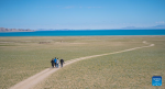 Tourists enjoy the scenery of Serling Tso Lake in southwest China`s Xizang Autonomous Region, June 22, 2024.(Xinhua/Tenzin Nyida)