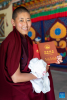 A Buddhist nun shows her diploma at the graduation ceremony at Tibet Buddhism University in Lhasa, southwest China`s Xizang Autonomous Region, June 30, 2024. A graduation ceremony was organized by the Tibet Buddhism University here on Sunday, awarding the `Chi Ram Pa` diploma (master`s degree) to 29 Buddhist nuns. (Xinhua/Tenzing Nima Qadhup)