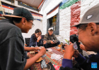 Customers play a poker game at a cafe on the Barkhor Street in Lhasa, southwest China`s Xizang Autonomous Region, July 5, 2024. Located at a century-old courtyard in the capital city of Xizang, this cafe with exquisite decorations is jointly operated by 28-year-old Tenzin Tegchok and his buddies. The courtyard is not only where Tenzin Tegchok was raised, but also a depot of his reminiscence. The cafe, for its part, has injected much vigor to the time-honored building that accommodates it. (Photo by Kalsang Yudron/Xinhua)