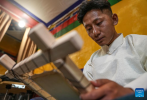 Tenzin Tegchok, a former thangka painter, creates a painting at his cafe on the Barkhor Street in Lhasa, southwest China`s Xizang Autonomous Region, July 5, 2024. Located at a century-old courtyard in the capital city of Xizang, this cafe with exquisite decorations is jointly operated by 28-year-old Tenzin Tegchok and his buddies. The courtyard is not only where Tenzin Tegchok was raised, but also a depot of his reminiscence. The cafe, for its part, has injected much vigor to the time-honored building that accommodates it. (Xinhua/Jigme Dorje)