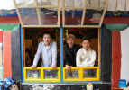 Tenzin Tegchok (R), Tenzin Kalsang (C) and Tashi Dorje pose for a photo at a cafe on the Barkhor Street in Lhasa, southwest China`s Xizang Autonomous Region, July 5, 2024. Located at a century-old courtyard in the capital city of Xizang, this cafe with exquisite decorations is jointly operated by 28-year-old Tenzin Tegchok and his buddies. The courtyard is not only where Tenzin Tegchok was raised, but also a depot of his reminiscence. The cafe, for its part, has injected much vigor to the time-honored building that accommodates it. (Xinhua/Jigme Dorje)