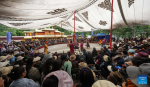 People watch a Tibetan opera performance at Norbulingka in Lhasa, southwest China`s Xizang Autonomous Region, Aug. 8, 2024. Tibetan opera performances are staged here from Aug. 4 to Aug. 10 in celebration of the traditional Shoton Festival, or Yogurt Festival. (Xinhua/Jigme Dorje)