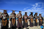 Villagers dressed in folk costume dance in Kejia Village of Pulan County, southwest China`s Xizang Autonomous Region, Sept. 9, 2024.  Originating in Pulan County, Pulan folk costume has been a traditional garment worn at celebrations for over a millennium. Weighing more than 20 kilograms, a piece of this unique costume is usually decorated with rare metals and jewels, like gold, silver, beeswax, coral and turquoise. (Xinhua/Sun Ruibo)